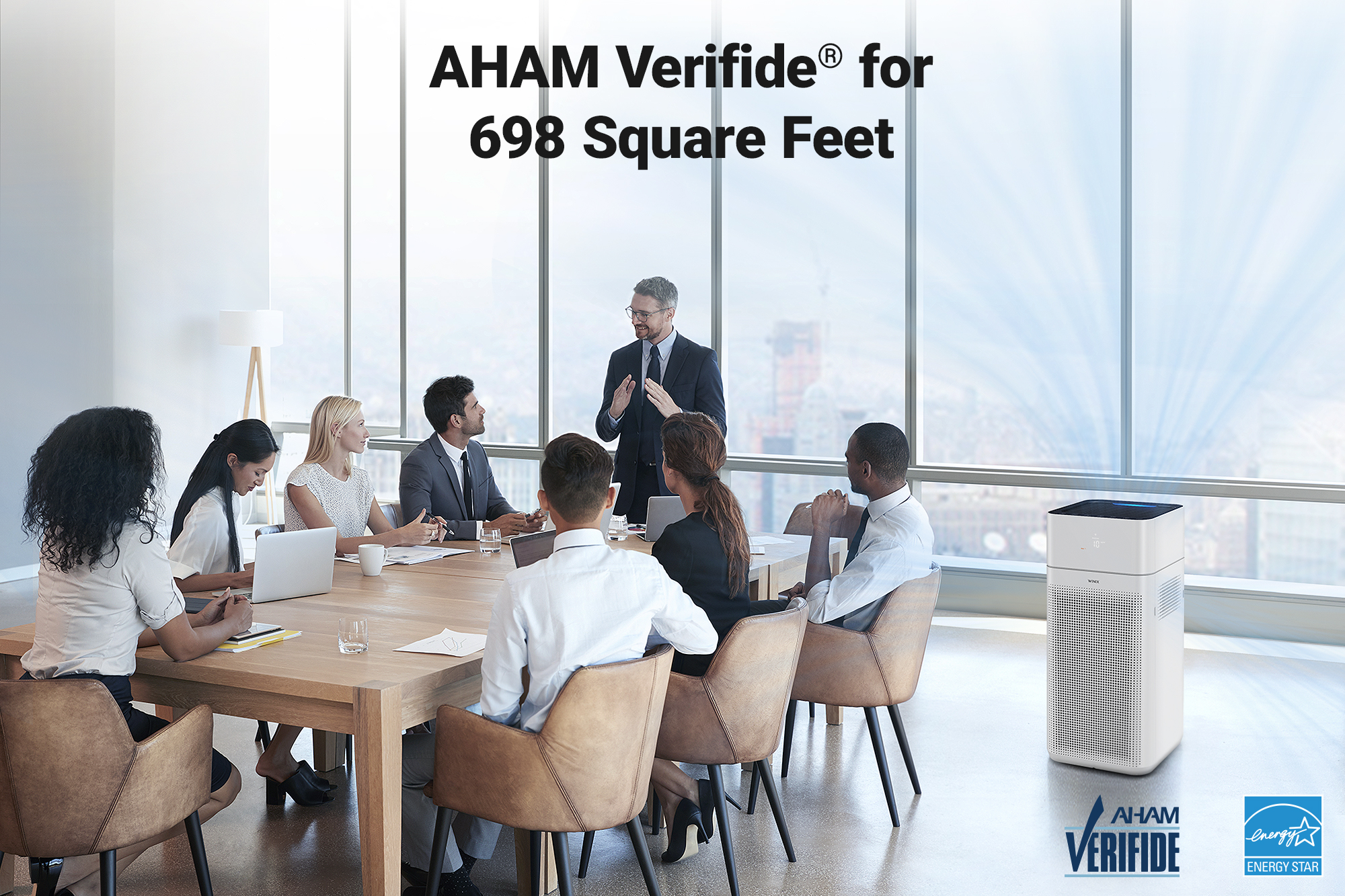 XQ air purifier in an office meeting setting with text saying AHAM verified for 698 square feet and AHAM verified logo and energy star logo in bottom corner of image
