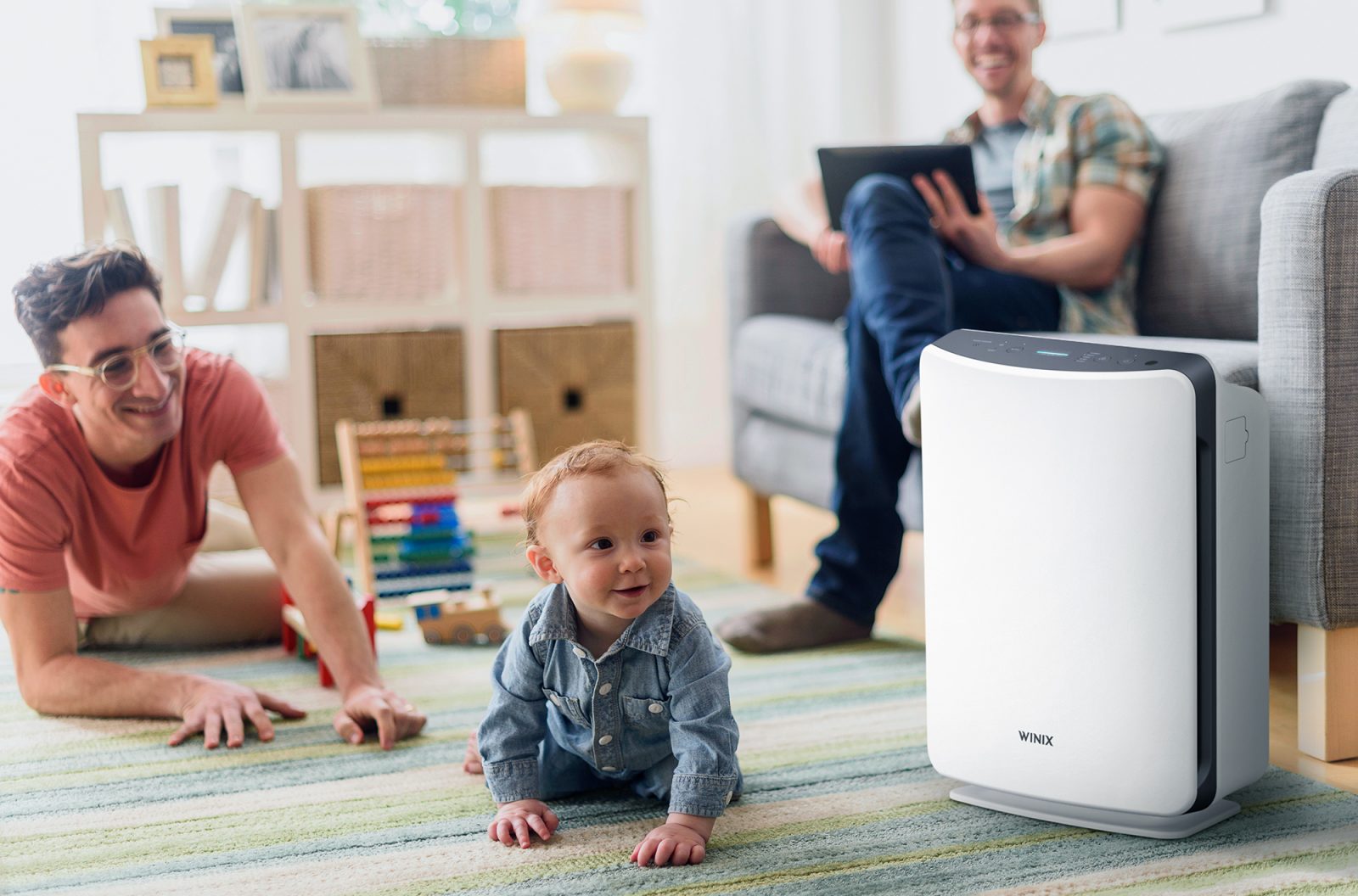 D360 air purifier on floor next to crawling toddler