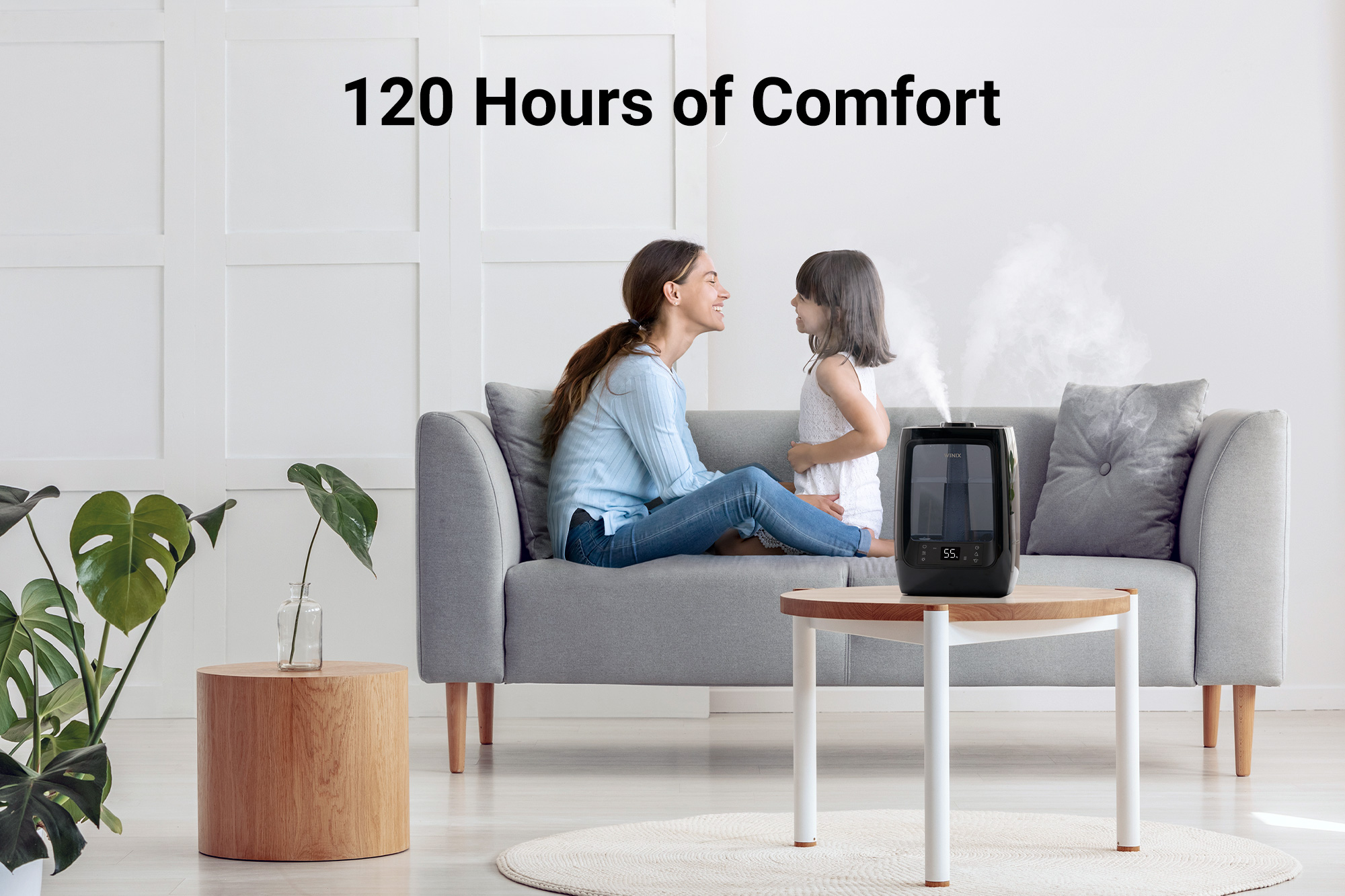 L200 Humidifier on side table next to woman and young child sitting on a couch and text saying 120 hours of comfort