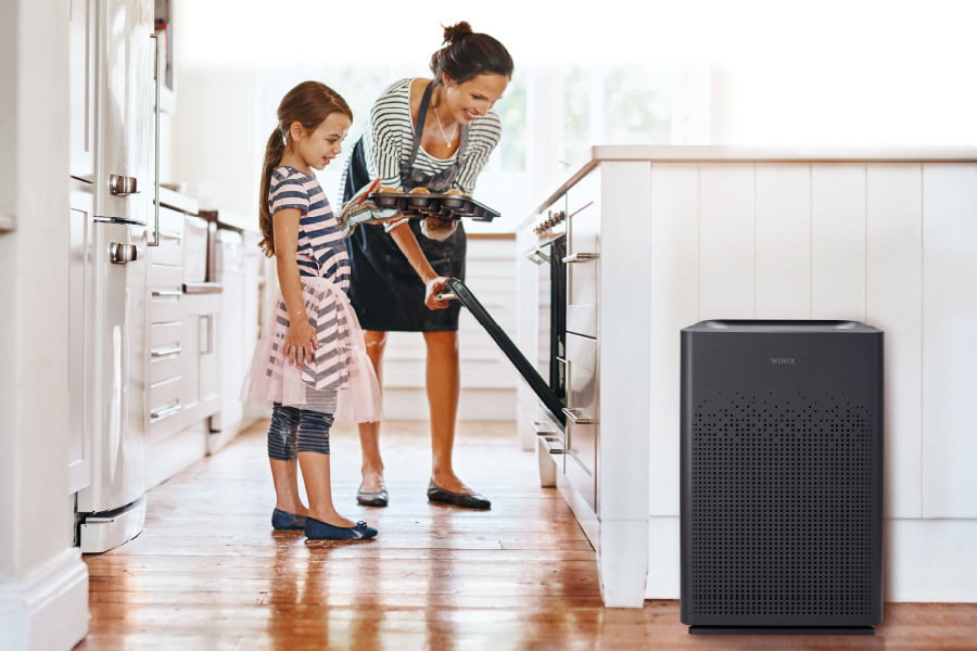Mother and daughter baking muffins with AM80 air purifier eliminating unpleasant odors