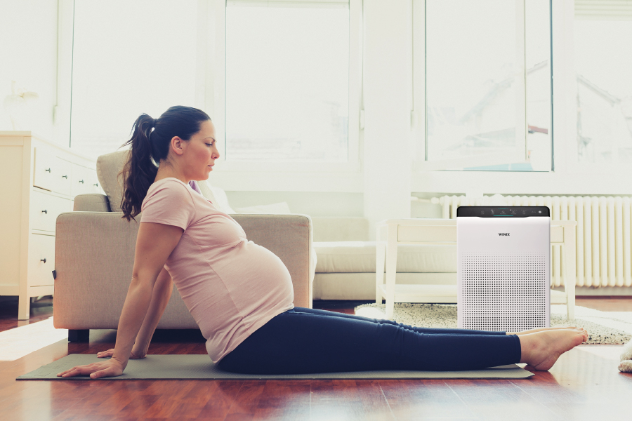Pregnant woman on floor stretching legs